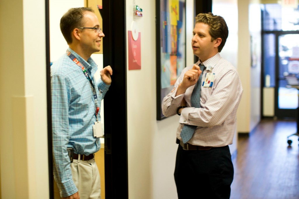 Dr. Romain and Dr. Taraman speaking in hallway