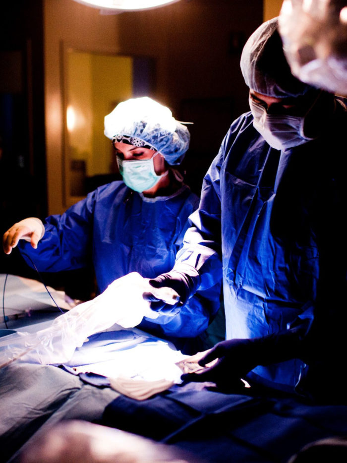 doctors in operating room working on patient