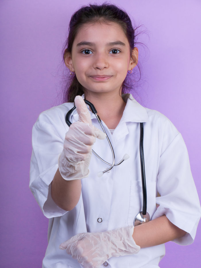 girl dressed as a doctor with thumbs up