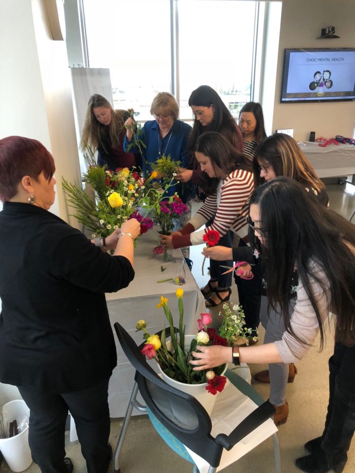Psychology department staff members creating flower arrangements at a recent retreat.
