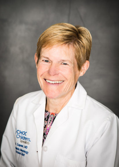 Professional headshot of Dr. Mary Zupanc, Pediatric Epileptologist at CHOC Children's, in a while labcoat on a gray background.