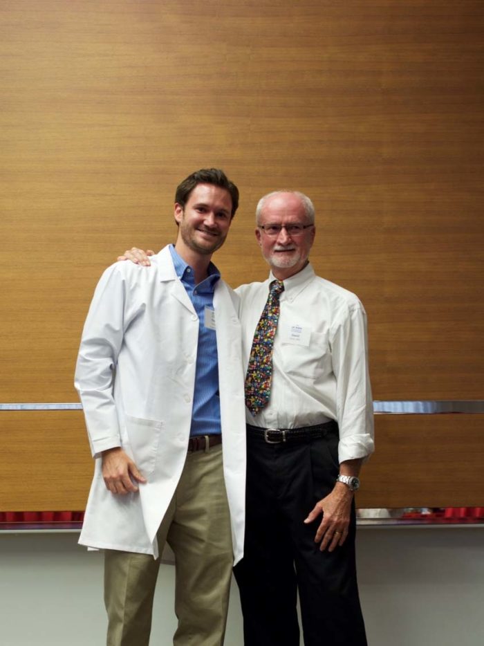 Dr. Hicks with his son Tim at his white coat ceremony, where residents receive their white coats for the first time.