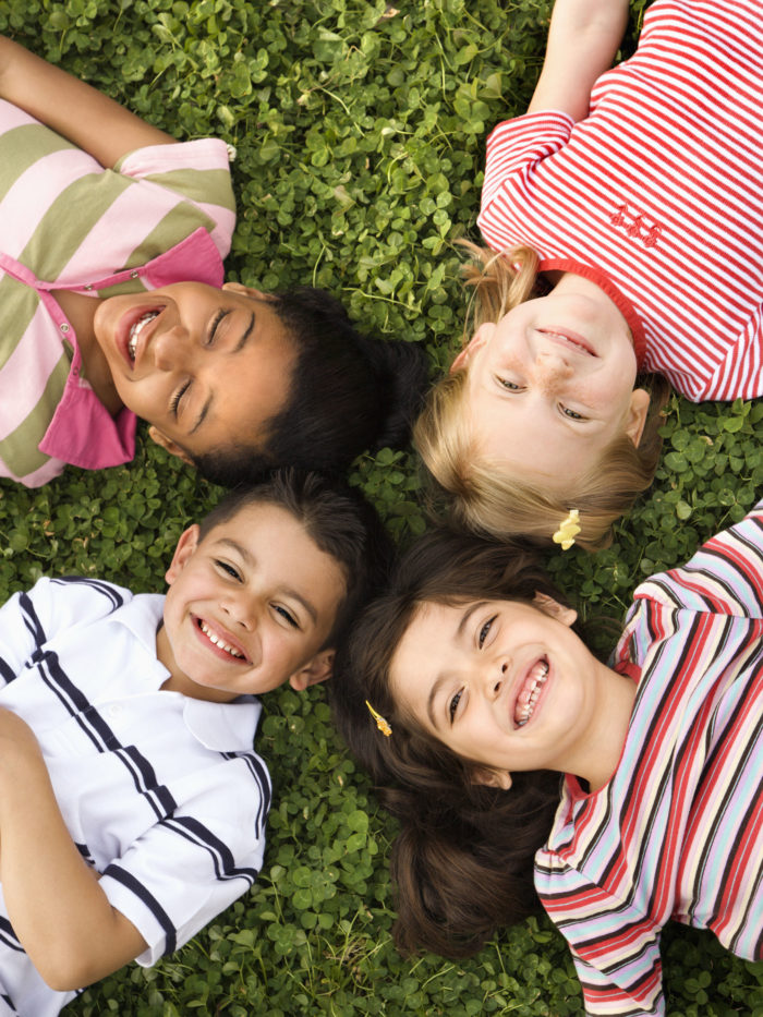 Children lying in clover