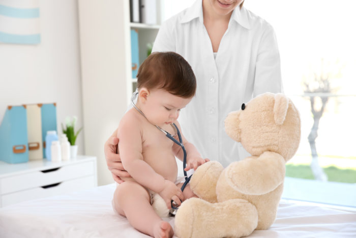 Baby and teddy bear at doctor's