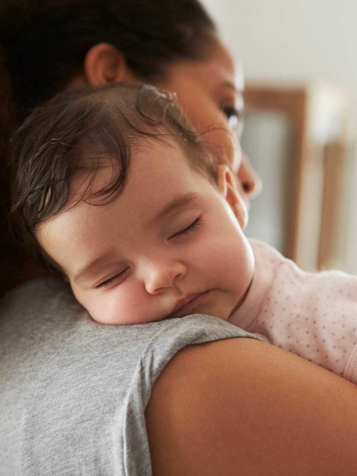 Baby sleeping on woman's shoulder