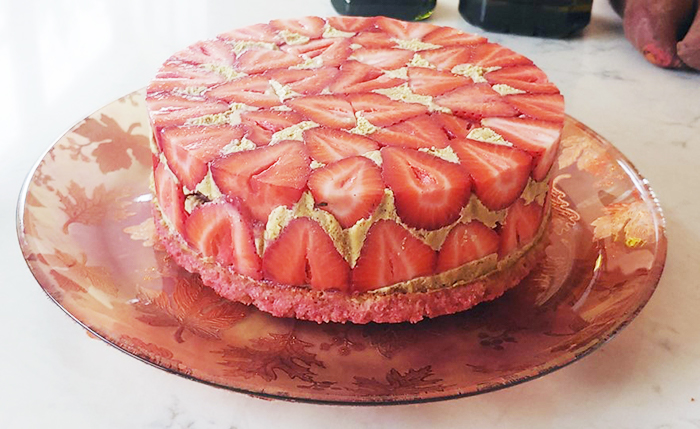 A cake with strawberries on a plate