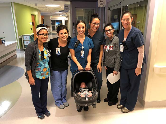 CHOC nurses pose in hospital hallway with baby Micah