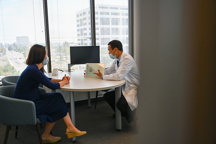 Dr. Peter Yu and a patient looking at an ipad at the Fetal Care Center of Southern California. 