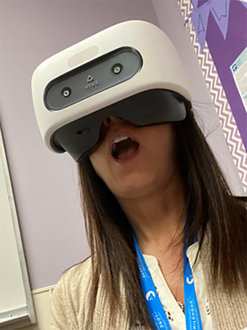 woman looks surprised while wearing a VR headset