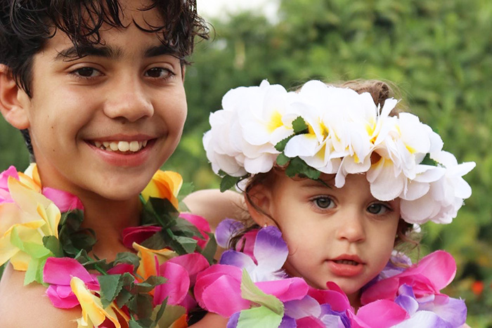Gabriel and Luna wearing hawaiian leis