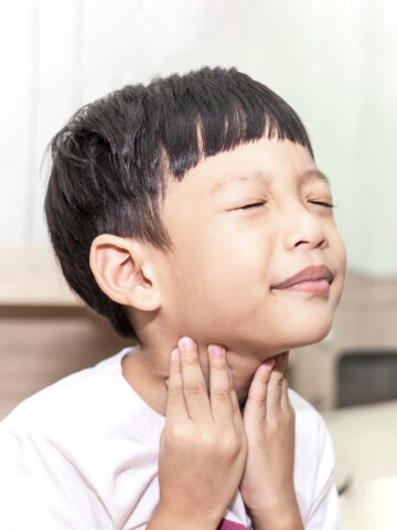 Child holds tonsils
