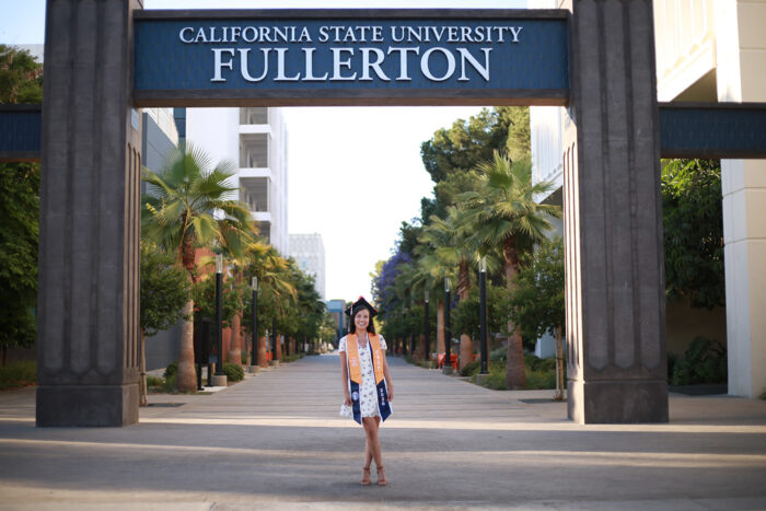 Liliana standing in front of California State University Fullerton sign