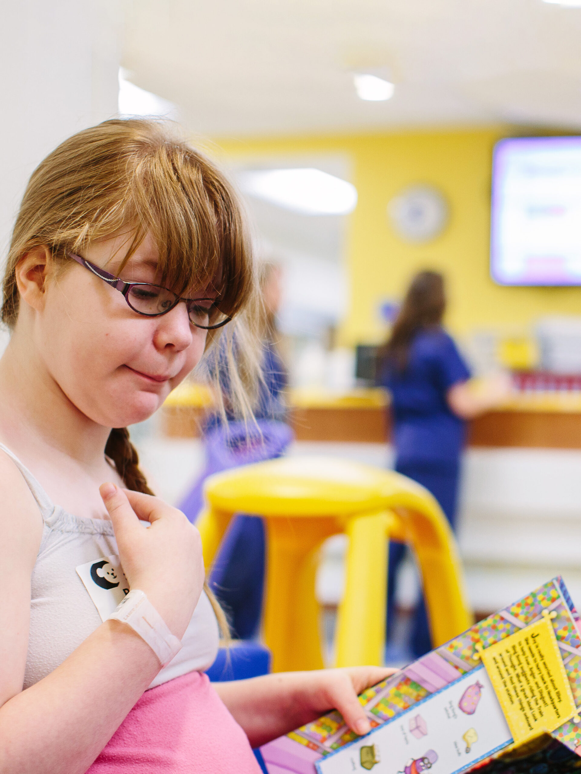 Child looks at book at CHOC Hospital in Orange - Foundation of Caring Lysosomal Storage Disorder Program
