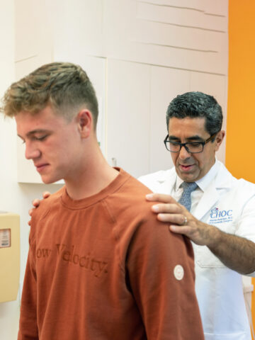 Dr. Aminian checks patient's spine