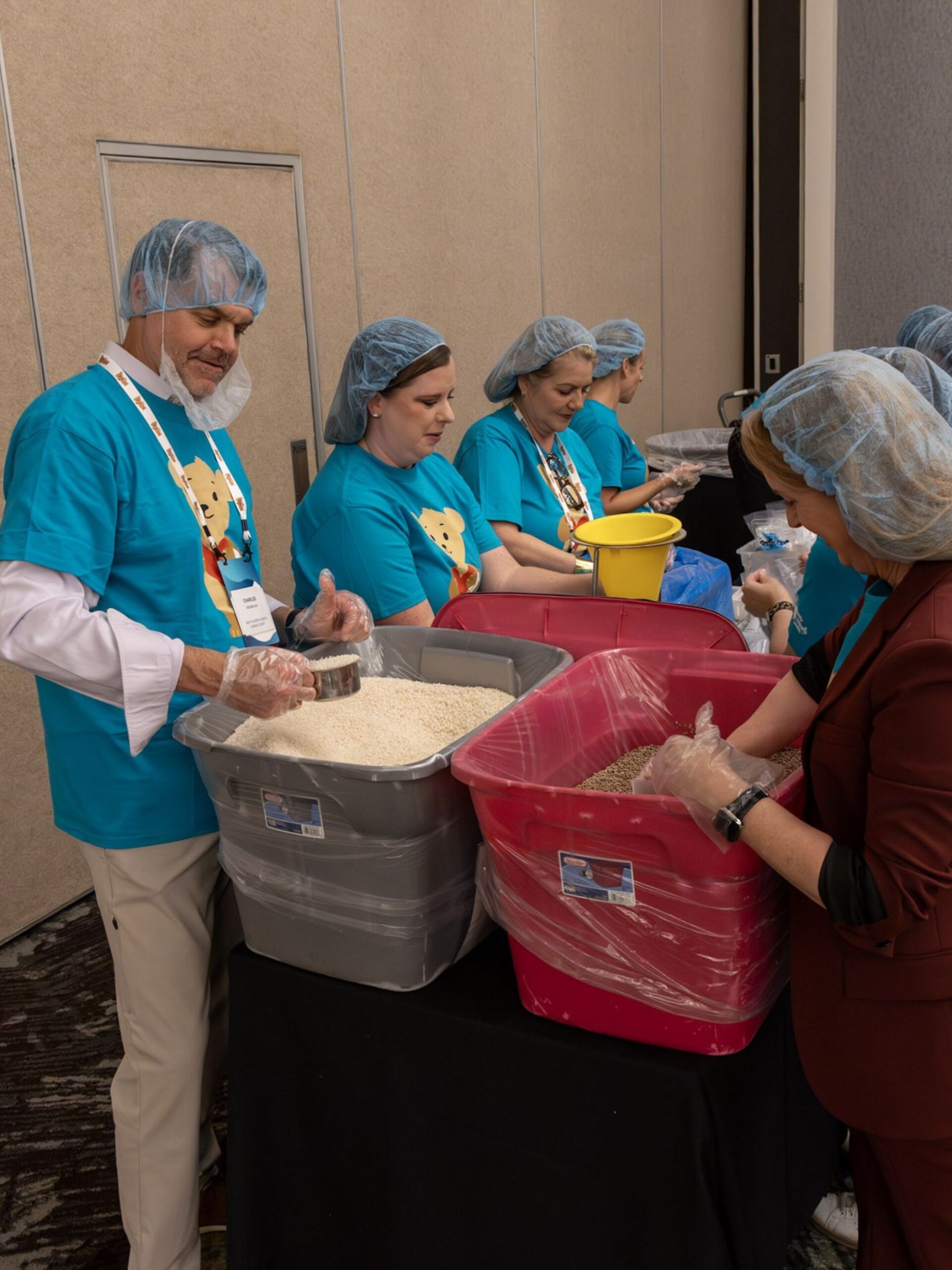 Group of people packing meals.